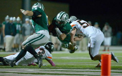 Leah Hogsten  |  The Salt Lake Tribune
Olympus' Quinn Meier scores a touchdown. Olympus High School leads Murray High School, 30-14 during their football game Friday, October 9, 2015 at Olympus High School.