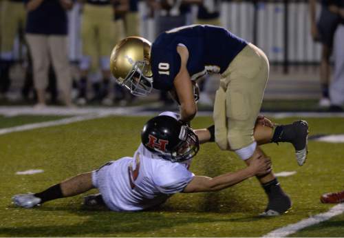 Francisco Kjolseth | The Salt Lake Tribune
Hurricane's Kyle Williams slides in for a tackle on Skyline's Seth Kaelin during the football season opener at Skyline on Thursday, Aug. 20, 2015.