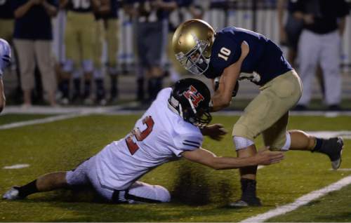 Francisco Kjolseth | The Salt Lake Tribune
Hurricane's Kyle Williams slides in for a tackle on Skyline's Seth Kaelin during the football season opener at Skyline on Thursday, Aug. 20, 2015.