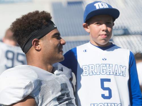 Rick Egan  |  The Salt Lake Tribune

Chase Riggs, 10, Orem, poses for a photo with Brigham Young line backer, Fred Warner (4) after the final practice of spring camp, at LaVell Edwards Stadium, Friday, April 1, 2016.