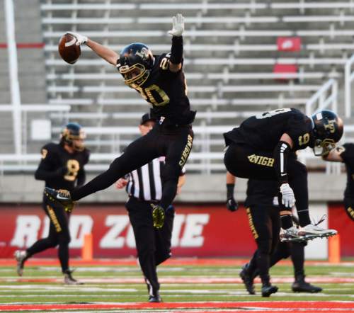 Steve Griffin  |  The Salt Lake Tribune

Lone Peak's Nate Bennett, left, and Michael Cannon celebrate a late turnover during the Class 5A football semifinal between Lone Peak and Bingham Rice-Eccles Stadium in Salt Lake City, Friday, November 13, 2015.