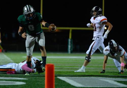 Leah Hogsten  |  The Salt Lake Tribune
Olympus' quarterback Sawyer Pierce scores a touchdown. Olympus High School leads Murray High School, 30-14 during their football game Friday, October 9, 2015 at Olympus High School.