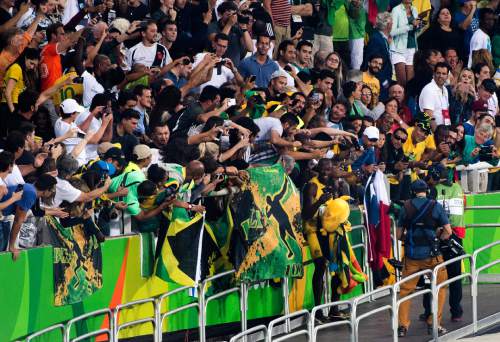 Rick Egan  |  The Salt Lake Tribune

Usain Bolt takes selfies with fans from Jamaica, after winning the mens 100m at the Olympic Stadium in Rio de Janeiro, Sunday, August 14, 2016.
