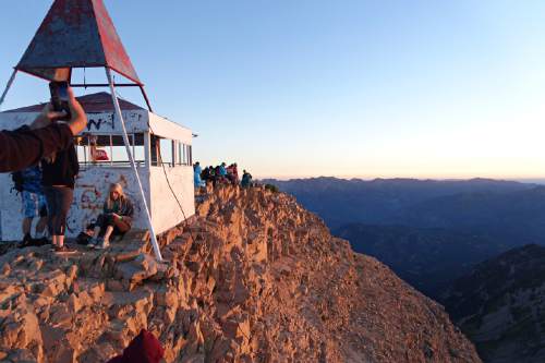 Lennie Mahler  |  The Salt Lake Tribune

Groups of hikers watch the sunrise at the summit of Mount Timpanogos on Sunday, July 24, 2016.
