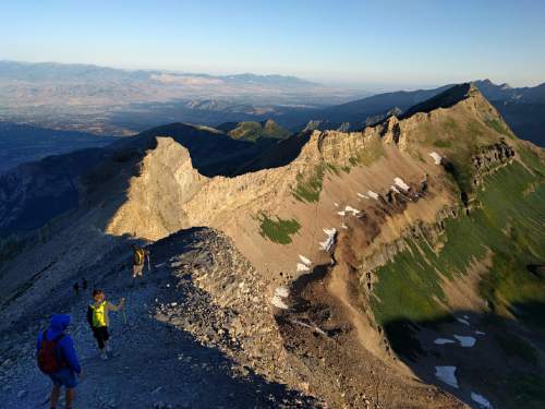 Lennie Mahler  |  The Salt Lake Tribune

Hikers descend Mount Timpanogos after sunrise on Sunday, July 24, 2016.