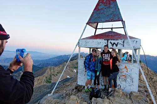 Lennie Mahler  |  The Salt Lake Tribune

Peter Wagner takes a Polaroid photo of Mike West, Morgan Warner, Michael Willden and Alysha Delange at sunrise at the summit of Mount Timpanogos on Sunday, July 24, 2016.