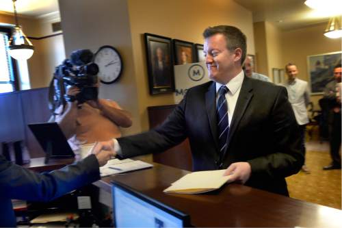 Scott Sommerdorf   |  The Salt Lake Tribune  
Campaign adviser Brian Henderson files signatures and paperwork with Justin Lee, deputy director of elections at the Utah lieutenant governor's office on behalf of Evan McMullin who is runnig for president, Monday, Aug. 15, 2016.