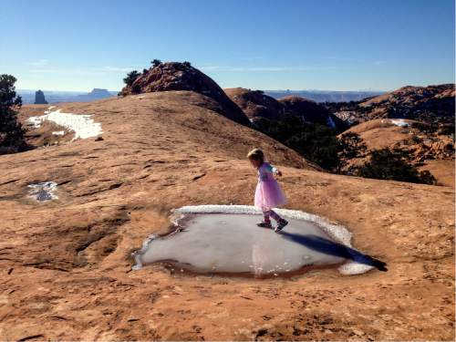 Erin Alberty  |  The Salt Lake Tribune

The author's daughter glides on an icy pothole Dec. 2, 2015 on Whale Rock in Canyonlands National Park.