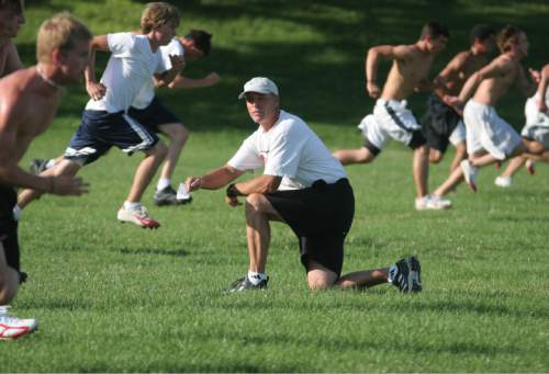 Larry Wall, coach of the Bountiful Football Team, works out his team Friday morning. 7/29/05 Jim Urquhart/Salt Lake Tribune
