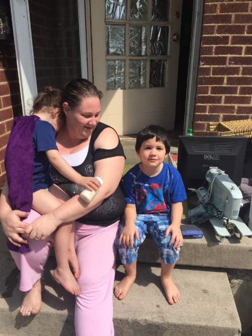 Christopher Smart  |  The Salt Lake Tribune

Amy Tabor and her two sons, Ellonzo, 6, (left) and Leo, 4, sit on the porch of a rented duplex in Rose Park shortly before being evicted. After missing the July rent, she owes thousands in attorney fees and penalties.