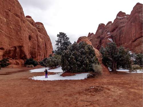 Erin Alberty  |  The Salt Lake Tribune

The author's daughter plays in snow near the Devils Garden campground Nov. 29, 2015 at Arches National Park.