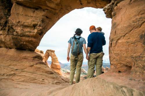 Chris Detrick  |  The Salt Lake Tribune
A family looks at Delicate Arch in Arches National Park Saturday March 5, 2016.