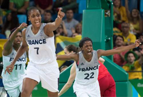 Rick Egan  |  The Salt Lake Tribune

Valeriane Ayayi (11) Sandrine Gruda (7) and Olivia  Epoupa (22)
of France,  celebrate as the cut down the lead, in in Olympic Women's basketball action, Canada vs. France, in Rio de janeiro, Tuesday, August 16, 2016.