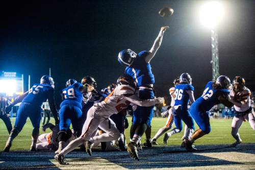 Chris Detrick  |  The Salt Lake Tribune
Bingham's Matt Degn (1) passes the ball under pressure from Mountain Crest's Mitch Stott (22) during the game at Bingham High School Friday November 6, 2015.  Bingham won the game 28-0.