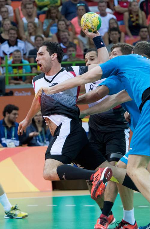 Rick Egan  |  The Salt Lake Tribune

Ahmed Elahmar (66) of Egypt is held by German defender Finn Lemke (6) in handball action, Egypt vs. Germany, at the Future Arena, in Rio de Janeiro, Monday, August 15, 2016.