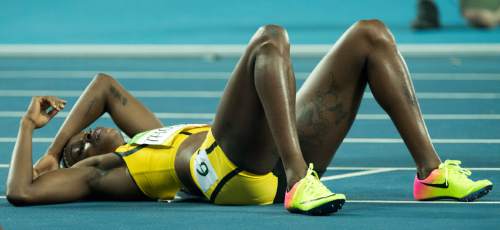 Rick Egan  |  The Salt Lake Tribune

Jamaica's Elaine Thompson, falls to the ground with exhaustion, after her gold medal finish, in the women's 100-meter hurdles, at the Olympic Stadium in Rio de Janeiro, Wednesday, August 17, 2016.
