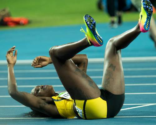 Rick Egan  |  The Salt Lake Tribune

Jamaica's Elaine Thompson, falls to the ground with exhaustion, after her gold medal finish, in the women's 100-meter hurdles, at the Olympic Stadium in Rio de Janeiro, Wednesday, August 17, 2016.