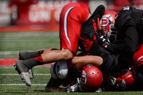Trent Nelson  |  The Salt Lake Tribune
Defenders collapse on Utah's Tyler Cooperwood during Utah's second fall scrimmage at Rice-Eccles Stadium in Salt Lake City, Tuesday August 16, 2016.