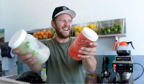 Al Hartmann  |  The Salt Lake Tribune 
Shaken not stirred.... After 12 years of running the Sweet Lake Limeade booth at the Downtown Farmer Market, Hoss Cone and wife Teri Rosquist have opened a brick and mortar store in Sugarhouse at Sweet Lake Limeade and Biscuits. Here, Hoss shakes up freshly made mint limeade and rasberry limeade in Mason jars before serving.