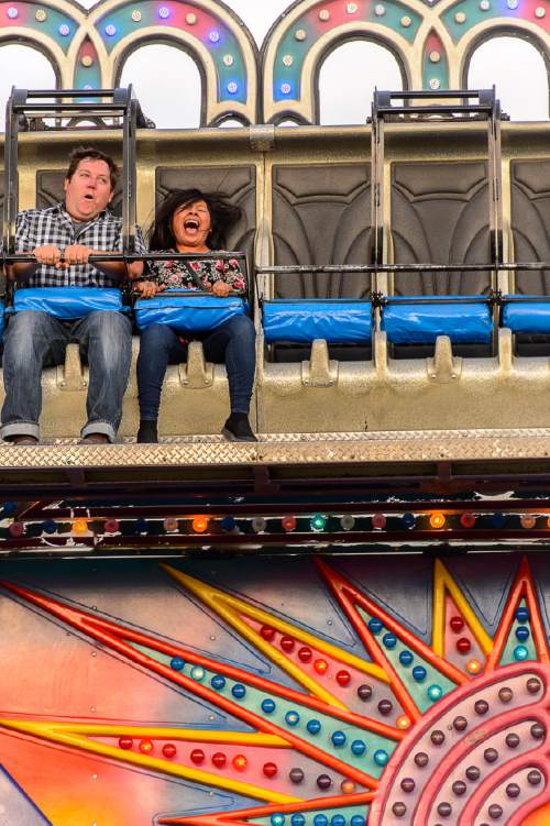 Trent Nelson  |  The Salt Lake Tribune
Eric Matesen and Lily Valerio ride the Gee Wizz on the opening day of the Salt Lake County Fair, Wednesday August 17, 2016, marking its 80th year with traditional fair events and modern entertainment. The Fair continues through the weekend at the Salt Lake County Equestrian Center in South Jordan.