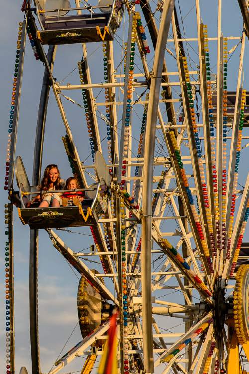 Trent Nelson  |  The Salt Lake Tribune
Riders on the ferris wheel on the opening day of the Salt Lake County Fair, Wednesday August 17, 2016, marking its 80th year with traditional fair events and modern entertainment. The Fair continues through the weekend at the Salt Lake County Equestrian Center in South Jordan.