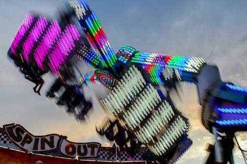 Trent Nelson  |  The Salt Lake Tribune
Riders on the Spin Out on the opening day of the Salt Lake County Fair, Wednesday August 17, 2016, marking its 80th year with traditional fair events and modern entertainment. The Fair continues through the weekend at the Salt Lake County Equestrian Center in South Jordan.