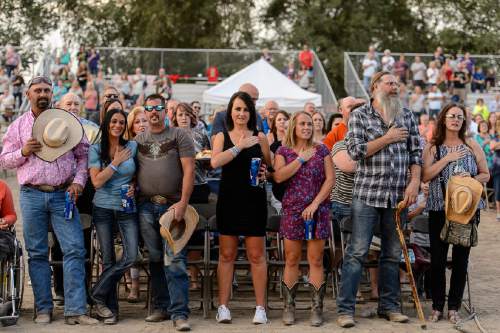 Trent Nelson  |  The Salt Lake Tribune
Country music fans say the Pledge of Allegiance on the opening day of the Salt Lake County Fair, Wednesday August 17, 2016, marking its 80th year with traditional fair events and modern entertainment. The Fair continues through the weekend at the Salt Lake County Equestrian Center in South Jordan.