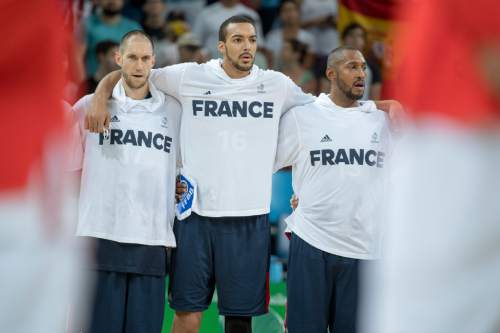 Rick Egan  |  The Salt Lake Tribune

Rudy Gobert (center) puts his arms around Kim Tillie (left) and Boris Diaw (right) as they sing along to the national anthem of France, before introductions, in mens Olympics quarterfinal basketball action, France vs.Spain, at Carioca Arena, in Rio de Janeiro, Monday, August 15, 2016.