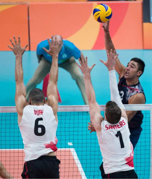 Rick Egan  |  The Salt Lake Tribune

Taylor Sander (3) of United States, hits the ball past Canadian defenders,  in Men's Olympic volleyball action at Ginásio do Maracanãzinho, in Rio de Janeiro, Sunday, August 7, 2016.