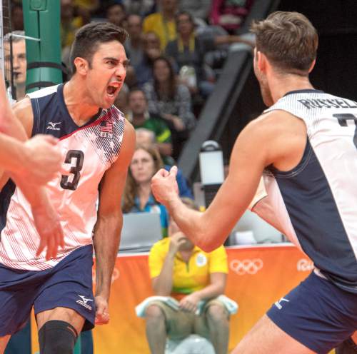 Rick Egan  |  The Salt Lake Tribune

Taylor Sander (3) reacts with Aaron Russell (2) of United States after a big point in game 4, in volleyball action USA vs. Brazil, in Rio de Janeiro, Thursday, August 11, 2016.