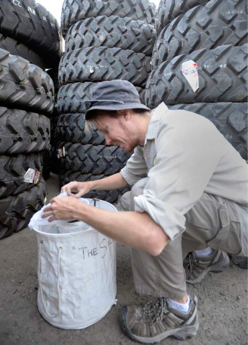 Al Hartmann  |  The Salt Lake Tribune 
Tyler Gilvarry, a research intern checks a mosquito trap specific to catching "Aedes Aegypti'" the zika carrying type of mosquito in Salt Lake City Tuesday Aug. 16.   The trap caught only one mosquito and was not the Aedes Aegypti.  The Salt Lake City Mosquito Abatement District does not have enough of these traps to effectively cover their whole jurisdiction.