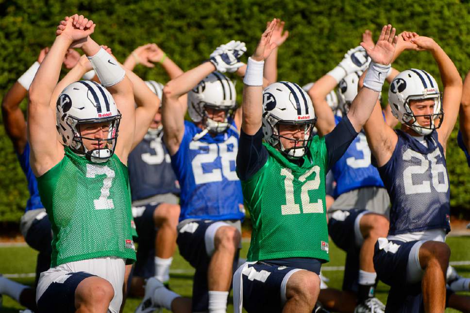 Trent Nelson  |  The Salt Lake Tribune
BYU quarterbacks Taysom Hill (7) and Tanner Mangum (12) at the first BYU fall camp practice under new coach Kalani Sitake, Friday August 5, 2016 in Provo.