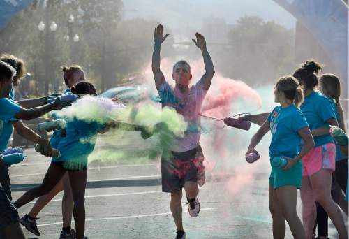 Scott Sommerdorf   |  The Salt Lake Tribune  
A runner crosses through the last checkpoint where they were doused with colors at the Color Run, billed as "the largest 5K event series in the world" brought its 2016 tour theme, "The Color Run Tropicolor World Tour" to Salt Lake City, Saturday, August 20, 2016.