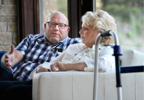 Scott Sommerdorf   |  The Salt Lake Tribune  
Attorney Adam Ford, left, speaks to his mother, Carolyn Ford, at his home in Highland, Wednesday, August 17, 2016. Ford, who uses a walker and a wheelchair to get around, has filed dozens of lawsuits this year to get Utah County businesses to comply with the Americans with Disabilities Act.