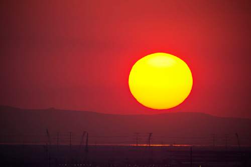 Lennie Mahler  |  The Salt Lake Tribune

The sun sets over the Stansbury Mountains, viewed from downtown Salt Lake City through smoky air that has mostly blown in from California wildfires Saturday, Aug. 20, 2016.