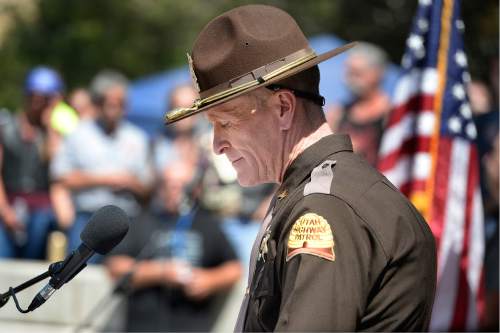 Scott Sommerdorf   |  The Salt Lake Tribune  
UHP Colonel Michael Rapich pauses while talking bout his own father who was a police officer while speaking at the Utah Law Enforcement Memorial following the "Ride for the Fallen", Sunday, August 21, 2016.