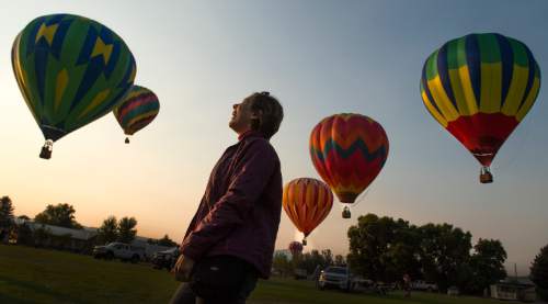 Leah Hogsten  |  The Salt Lake Tribune
Kelly Wallace Wade of Prescott, AZ giggles as she watches hot air balloons take to the skies early Friday, August 19, 2016 to kick off the Ogden Valley Balloon Festival, today through Sunday in Eden Park. The event features approximately 15 hot air balloons which are the focus for 5 launches and one balloon glow throughout the weekend.