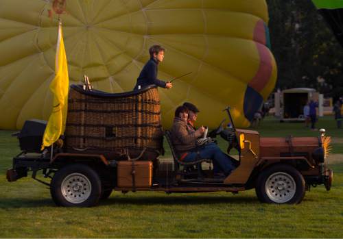 Leah Hogsten  |  The Salt Lake Tribune
l-r Mason Maurer, Jody Dana and driver JP Price take off in Price's custom support car for "The Wild Thing" hot air balloon. Hot air balloons took to the skies early Friday, August 19, 2016 to kick off the Ogden Valley Balloon Festival, today through Sunday in Eden Park. The event features approximately 15 hot air balloons which are the focus for 5 launches and one balloon glow throughout the weekend.
