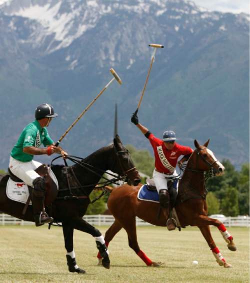 Trent Nelson  |  Tribune file photo
Robert Koehler, right, playing for Miller's 4Runners, reaches up to take a shot, with Dean's Demons' player Luis Saracco defending at left during the first ever Pharmacy Cup Champagne Brunch & Polo Match. The event was held in June 2009 at the Salt Lake County Equestrian Park in South Jordan.