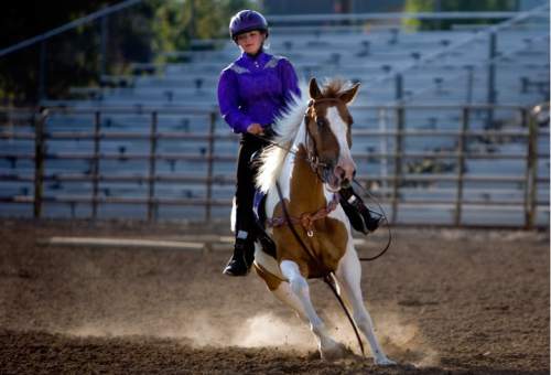 Kim Raff  |  Tribune file photo
River Schiffman rides Rikkii during the horse trail course during the 4-H Horse Show at the South Jordan Equestrian Park in South Jordan in 2012.