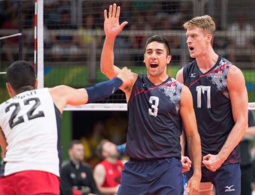 Rick Egan  |  The Salt Lake Tribune

Erik Shoji (22) Taylor Sander (3) and Maxwell Holt (17) celebrate after scoring a point for the  United States in Men's Olympic volleyball action, United States vs. Canada, at Ginásio do Maracanãzinho, in Rio de Janeiro, Sunday, August 7, 2016.