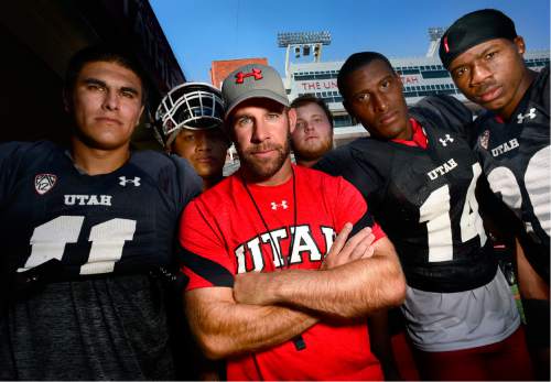 Scott Sommerdorf   |  The Salt Lake Tribune  
Utah defensive coordinator Morgan Scalley, center, poses for a photo with some of his defensive players, Saturday, August 20, 2016.