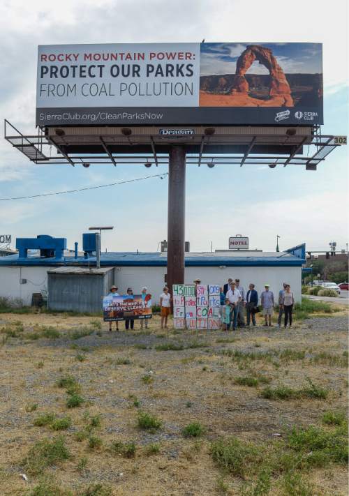 Francisco Kjolseth | The Salt Lake Tribune
Clean air, public health and national park advocates highlight the need for the Environmental Protection Agency's (EPA) recently approved plan to reduce coal pollution in beloved national parks such as Arches, Canyonlands and Zion. Included in their march to Rocky Mountain Power the group pass posed for photos below a Sierra-Club funded billboard before delivering the petition signatures asking the utility not to sue to stop the EPA's plan.