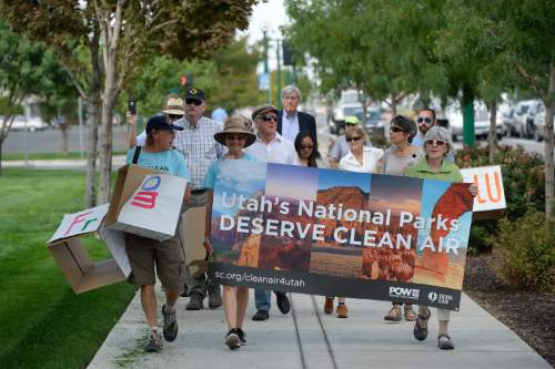 Francisco Kjolseth | The Salt Lake Tribune
Clean air, public health and national park advocates march in support of the Environmental Protection Agencyís (EPA) recently approved plan to reduce coal pollution in beloved national parks such as Arches, Canyonlands and Zion. The group marched to Rocky Mountain Power headquarters in Salt Lake City on Tuesday, Aug. 23, 2016,  to deliver a petition with over 43,000 signatures asking the utility not to sue to stop the EPAís plan.