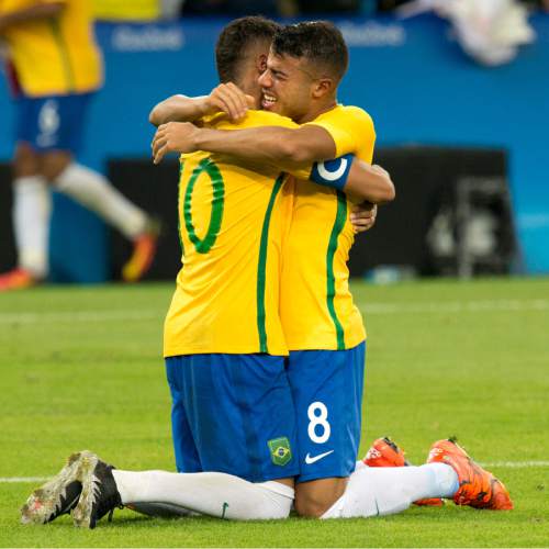 Rick Egan  |  The Salt Lake Tribune

Neymar (10) hugs Rafinha (8) of Brazil, after converting the winning penalty in a 5-4 shootout win for Brazil, in gold medal soccer action at Maracanã Stadium in Rio de Janeiro, Friday, August 19, 2016.