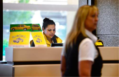 Scott Sommerdorf   |  The Salt Lake Tribune  
Yellow Cab employee Elbia Rojas sits in one of the two new Yellow Cab booths inside the terminal at Salt Lake City International Airport, Friday, August 19, 2016. Yellow, Ute and City cabs are no longer using the city's taxi stands at the airport. They say they have essentially been crowded out by the 400-plus other cab companies that appeared after deregulation there, and it isn't worth their time to be in the long queues.