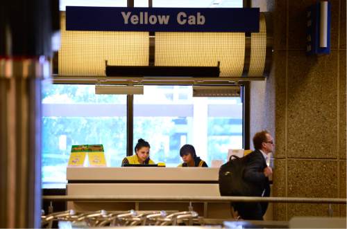 Scott Sommerdorf   |  The Salt Lake Tribune  
Yellow Cab employees including Elbia Rojas, left, sit in one of the two new Yellow Cab booths inside the terminal at Salt Lake City International Airport waiting for customers, Friday, August 19, 2016. Yellow, Ute and City cabs are no longer using the city's taxi stands at the airport. They say they have essentially been crowded out by the 400-plus other cab companies that appeared after deregulation there, and it isn't worth their time to be in the long queues.