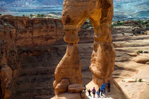 Chris Detrick  |  The Salt Lake Tribune
A family poses for a picture under Delicate Arch in Arches National Park on Saturday, March 5, 2016.