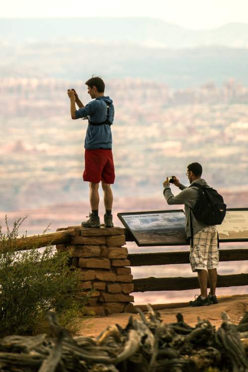 Chris Detrick  |  The Salt Lake Tribune
Neel Largerom, left, and Laurent Hamon, both of France, take pictures at Grand View Point in the Island in the Sky District at Canyonlands National Park Wednesday August 24, 2016.