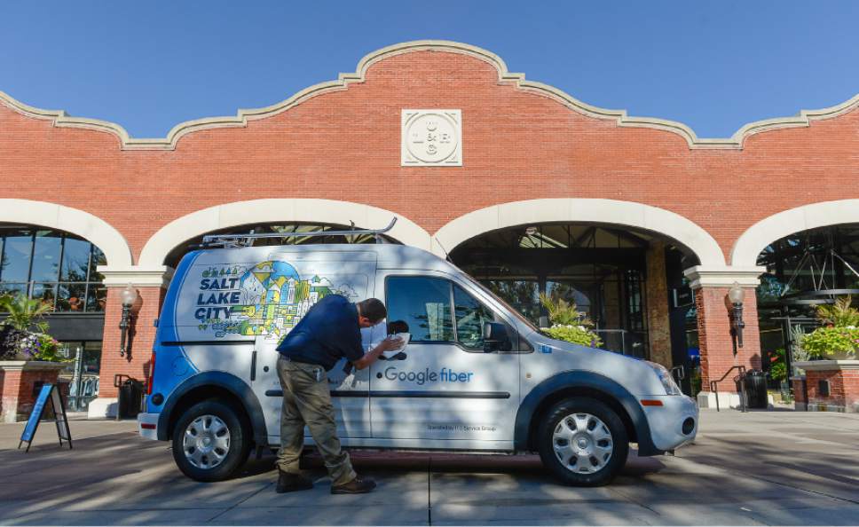 Francisco Kjolseth | The Salt Lake Tribune
Job Chadwick wipes down a Google car prior to the start of an announcement by Google Fiber during a grand opening-type event at their offices in Trolley Square -- referred to as Fiber Space -- on Wednesday, Aug. 23, 2016.